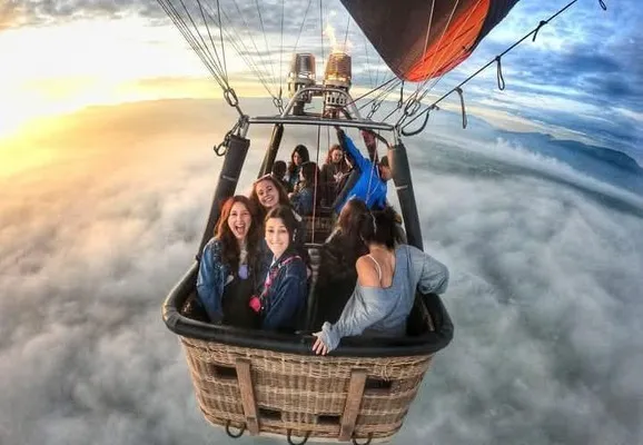 Grupo de amigos que escogieron la mejor hora para viajar en globo y disfrutar al máximo esta grandiosa aventura.