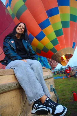 Seated woman prepares for adventure while reflecting on how does a hot air balloon work beautifully.