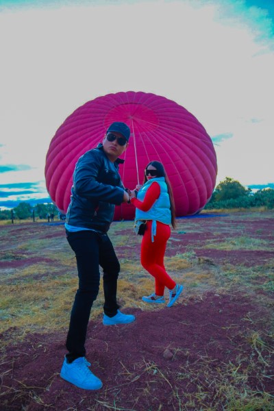 Couple ready to begin a hot air balloon ride for two with professional equipment, a romantic atmosphere, and certified safety.